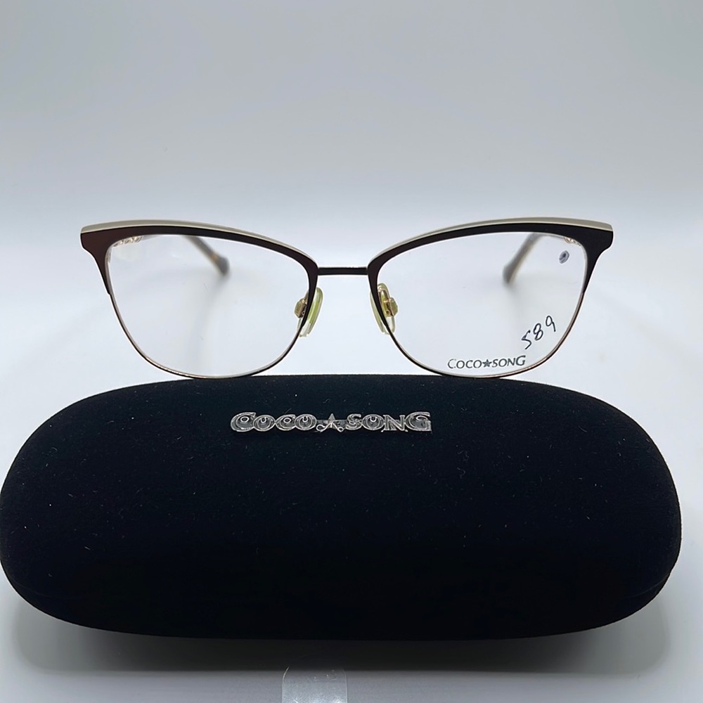 NWOT. Coco Song Optical frames. Gold and black rims with feather accent.
